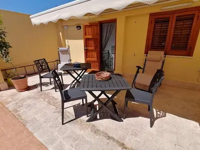 a group of chairs and a table on a patio at Terrazza al mare in Santa Flavia