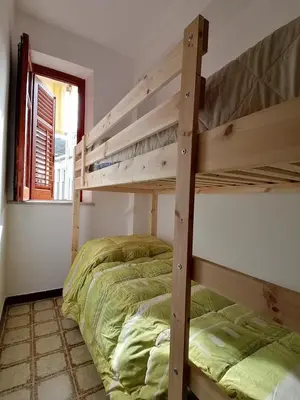 a bedroom with two bunk beds and a window at Terrazza al mare in Santa Flavia