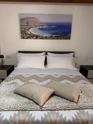 a bed with two pillows on top of it at A Casa di Frank in Palermo