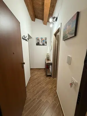 a hallway with a door and a table in a room at A Casa di Frank in Palermo