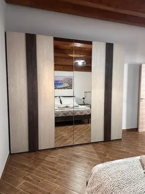 a bedroom with a mirror wall with a bed in it at A Casa di Frank in Palermo