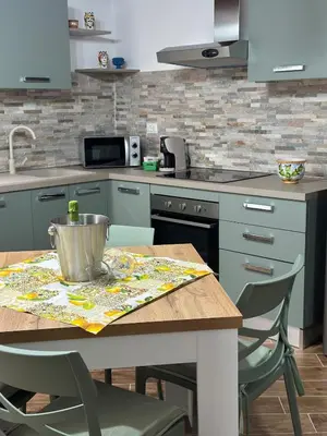 a kitchen with a table with a bucket on it at A Casa di Frank in Palermo