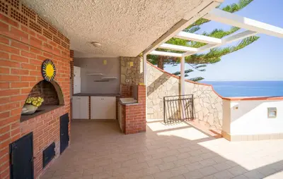 a balcony with a kitchen and a view of the ocean at Nice Home In Altavilla Milicia in Altavilla Milicia