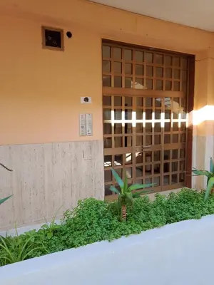a building with glass doors and plants in front of it at Al49house in Palermo