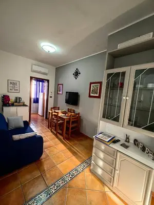 a living room with a blue couch and a table at Al49house in Palermo