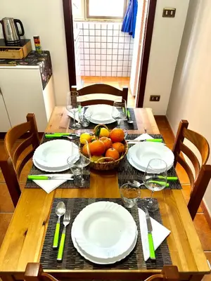 a table with plates and a bowl of fruit on it at Al49house in Palermo
