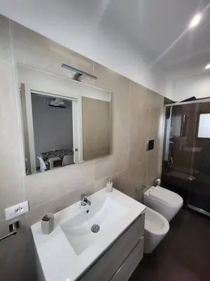 a bathroom with a sink and a toilet and a mirror at Sguardo a Ponente in Castellammare del Golfo