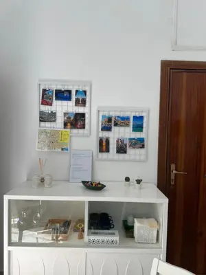 a white cabinet in a room with pictures on the wall at Appartamento Nonna Rosalba in Palermo