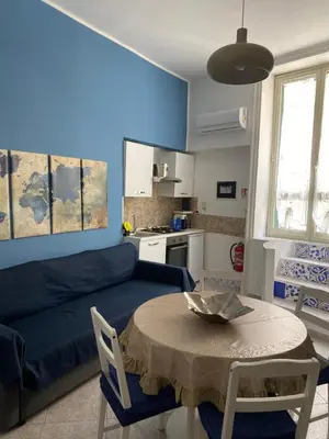 a living room with a blue couch and a table at Appartamento Nonna Rosalba in Palermo