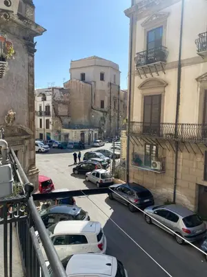 a city street with cars parked in a parking lot at Appartamento Nonna Rosalba in Palermo