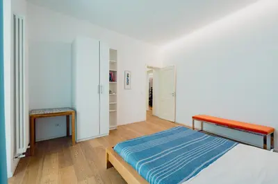 a bedroom with a bed and a bench in it at Santa Sofia con Terrazza by Wonderful Italy in Palermo