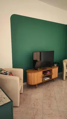 a living room with a flat screen tv on a table at Casa GADA in Palermo