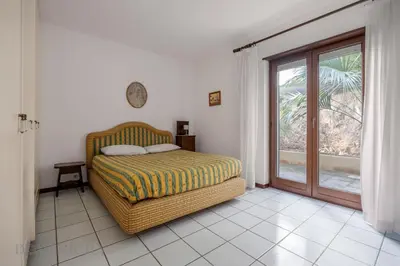 a living room with a couch and a table at Onda Blu Addaura by DomuSicily in Palermo
