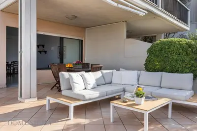 a patio with chairs and a table on a roof at Onda Blu Addaura by DomuSicily in Palermo