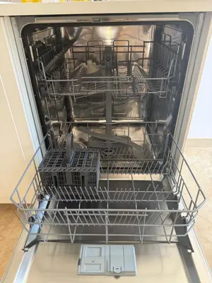 an open dishwasher with dishes inside of it at Carol's Sicily Dream in San Vito lo Capo