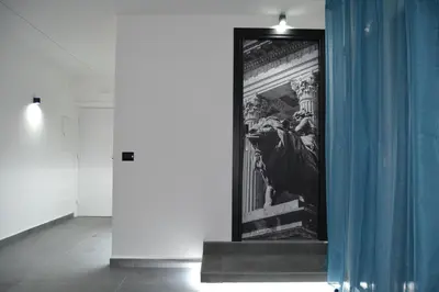 a framed picture of a lion on a wall with a blue curtain at Dimora Garibaldi in Palermo