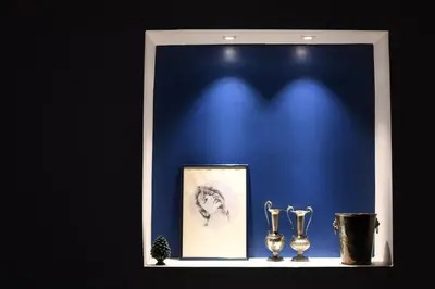 a shelf with two trophies and a picture on it at iFlat Casa Riccino in Palermo
