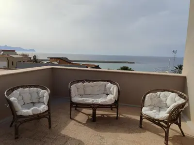 two chairs on a balcony with a view of the ocean at Albachiara in Balestrate