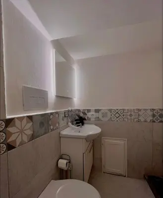 a bathroom with a white toilet and a sink at Ausa 20 - Tra Storia e Mare in Palermo