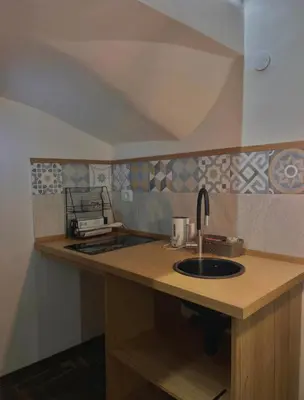 a kitchen with a sink and a counter top at Ausa 20 - Tra Storia e Mare in Palermo