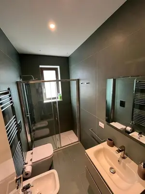 a bathroom with a shower and a toilet and a sink at Giunone Garden in Palermo