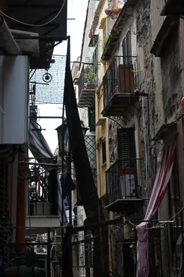 an alley with buildings and balconies and clotheslines at Suitt Drims 6 in Palermo