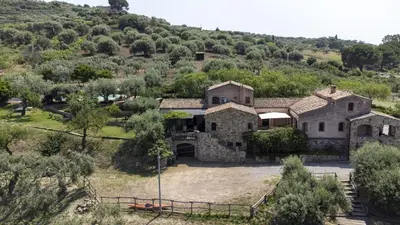an old stone house with a hill in the background at Villa Passulunara 14 by Massimo Villas in Lascari