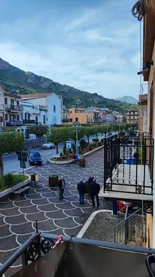 a view of a courtyard with trees and buildings at casa Fontana in Capaci