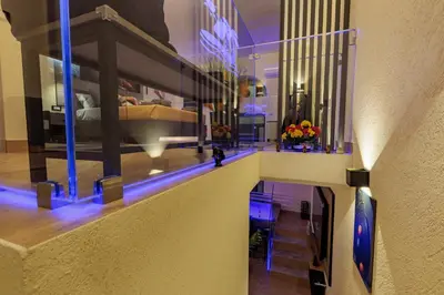 a room with a bed and a staircase with blue lights at A' Casuzza Suite Room in Porticello