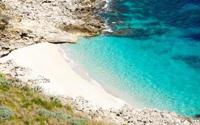an aerial view of a beach with blue water at Endless summer in Castelluzzo