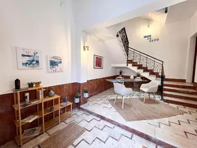 a living room with stairs and a table and chairs at Da Jaco in Castellammare del Golfo