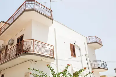 a white building with balconies on it at Da Jaco in Castellammare del Golfo