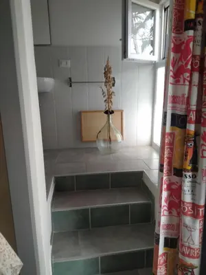 a stairway with a flower in a vase on it at La Pergola sul mare in Mandra Capreria