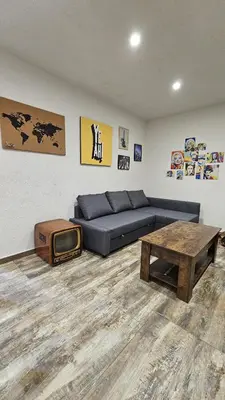 a living room with a couch and a table at Isula SeaView Apartments in Isola delle Femmine