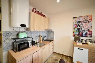 a kitchen with a sink and a microwave at Isula SeaView Apartments in Isola delle Femmine