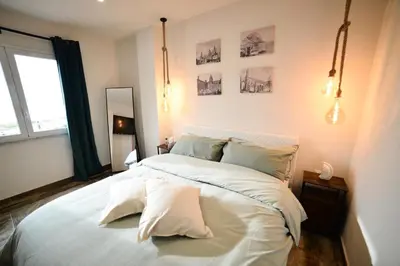 a bedroom with a large bed with white sheets and pillows at Isula SeaView Apartments in Isola delle Femmine