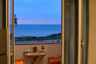 a living room with a couch and a coffee table at Isula SeaView Apartments in Isola delle Femmine