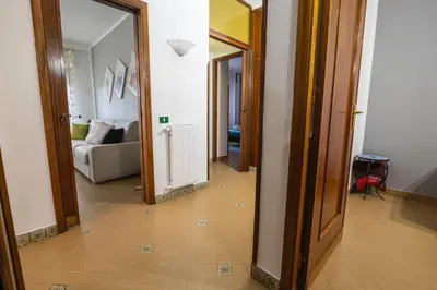 a hallway with a mirror and a living room at Sicily Wonders, 2 minute walk to the beach in Villagrazia