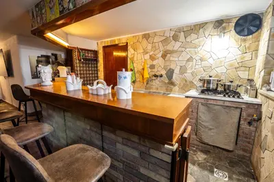 a kitchen with a counter and a stone wall at Sicily Wonders, 2 minute walk to the beach in Villagrazia