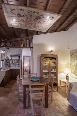 a dining room with a wooden table and chairs at Casa Conigli con piscina condivisa in Terrasini