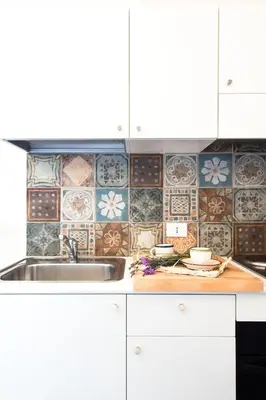 a kitchen with a sink and a tile wall at Ulivo Blu Holiday Homes by Wonderful Italy in Castellammare del Golfo
