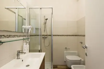 a bathroom with a shower and a sink and a toilet at Ulivo Blu Holiday Homes by Wonderful Italy in Castellammare del Golfo