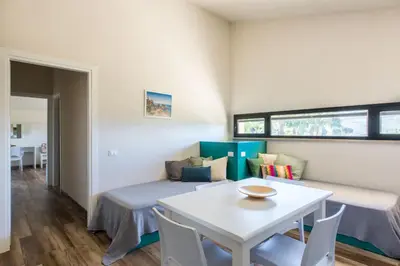 a room with a bed and a table and chairs at Ulivo Blu Holiday Homes by Wonderful Italy in Castellammare del Golfo