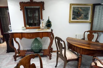 a room with a table and chairs and a mirror at Casa Chiarenza in Castellammare del Golfo