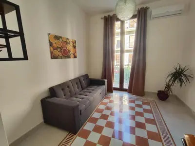 a living room with a couch and a checkered floor at Palazzo Orangea 1 piano in Bagheria