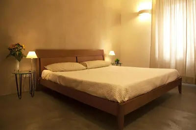 a bed in a bedroom with two tables and two lamps at Rosalmar B&B in Palermo