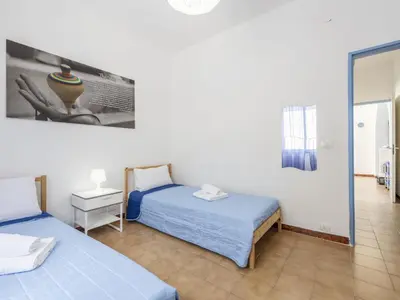 a room with two beds and a mirror at Apartment Pietra Marina by Interhome in Balestrate