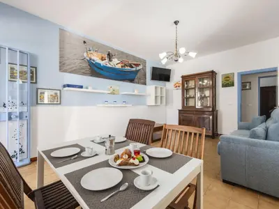 a dining room and living room with a table and chairs at Apartment Pietra Marina by Interhome in Balestrate