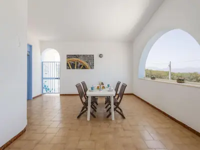 a dining room with a white table and chairs at Apartment Terrazza sul Mare by Interhome in Balestrate