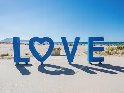 a sign that reads love on the beach at Apartment Terrazza sul Mare by Interhome in Balestrate